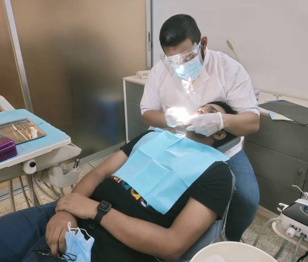 Dr. Arafath performing clinical dental procedure in operatory chair